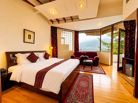  ManuAllaya's rooms have large windows framing the mountains