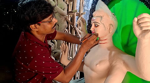 Gobindo Nath drawing the eyes of Kartik