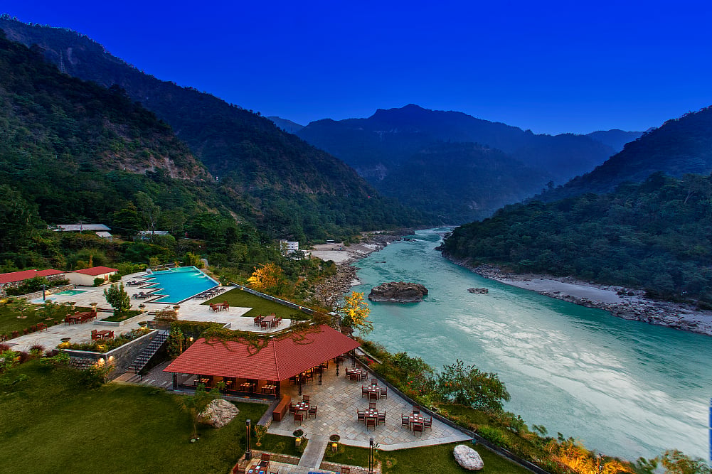 Aloha On The Ganges offers riverside stays with yoga, spa treatments, regional Uttarakhand cuisine, and evening flute performances