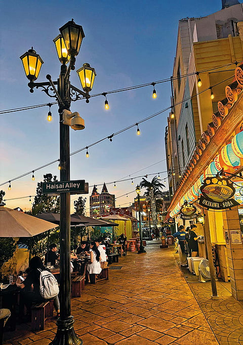 The American Village has numerous alleys adorned with twinkling fairy lights and lined with little cafés