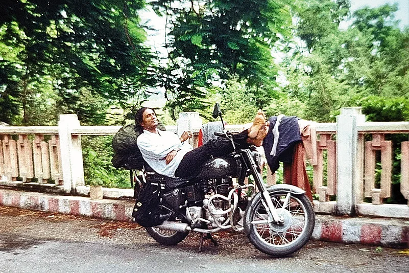 Napping as clothes dry on the railing of a bridge after bathing in a roadside stream in Himachal Pradesh