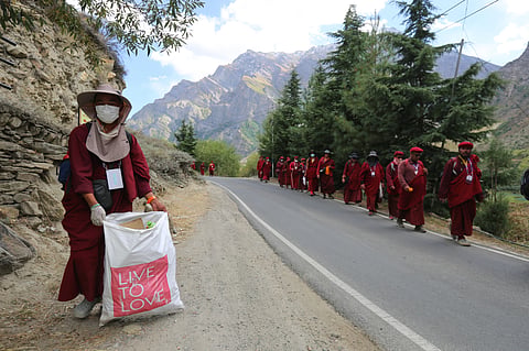 Drukpa Kung Fu Nun picking up trash along the way
