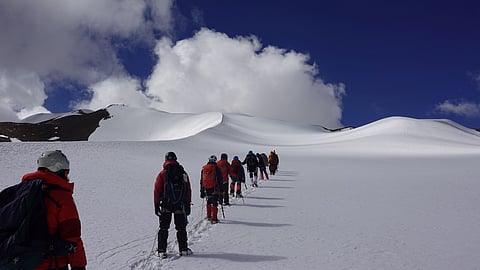 Climbers ascend a high-altitude peak in the Chang Chenmo region