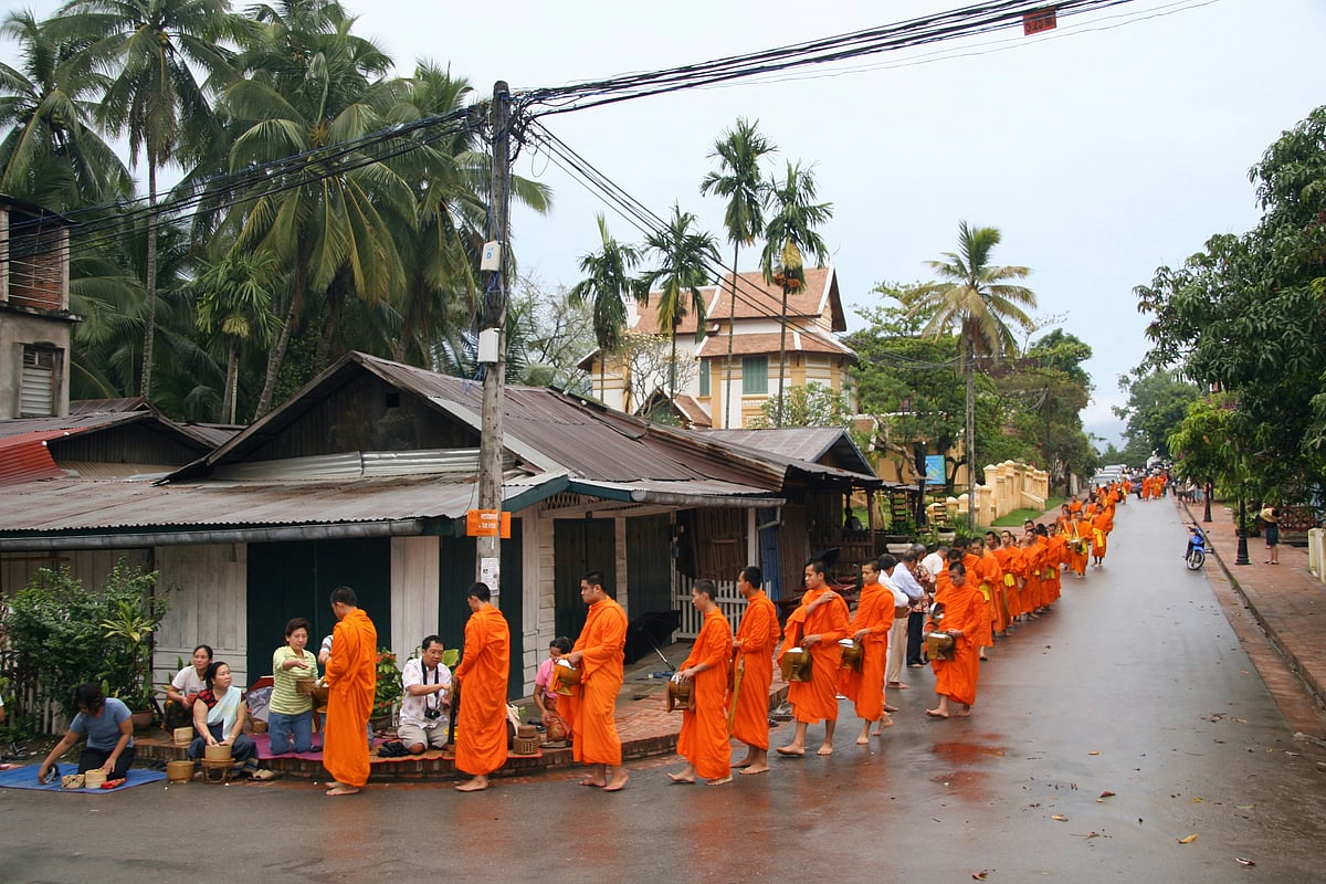 Buddhist monks collecting food offerings from residents in Luang Prabang