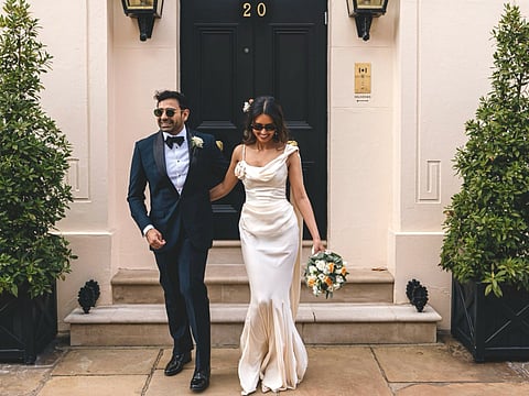 Nayyar in a sculptural dress, Nandha in classic Huntsman Savile Row tailoring