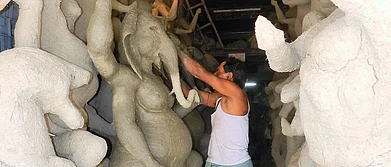 An artisan working on a idol