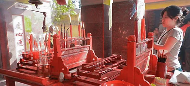 A woman prays at the temple of Tong Achew in Achipur, West Bengal