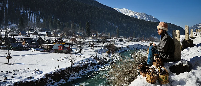 A kangri seller takes a break near the village - Manek S. Kohli