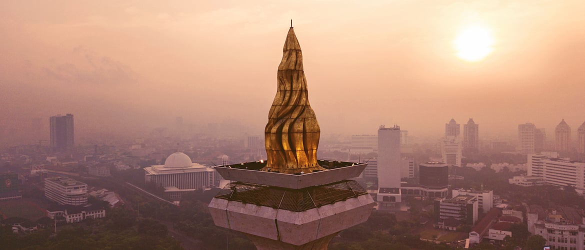 The Flame of Independence at the Monas Tower, which is illuminated in the night.