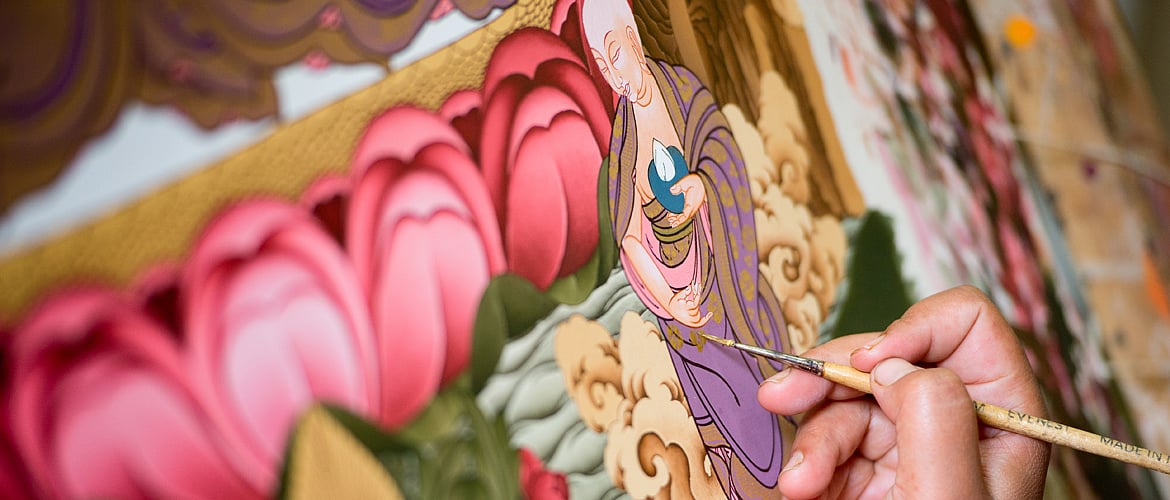 An artist working on a Thangka painting