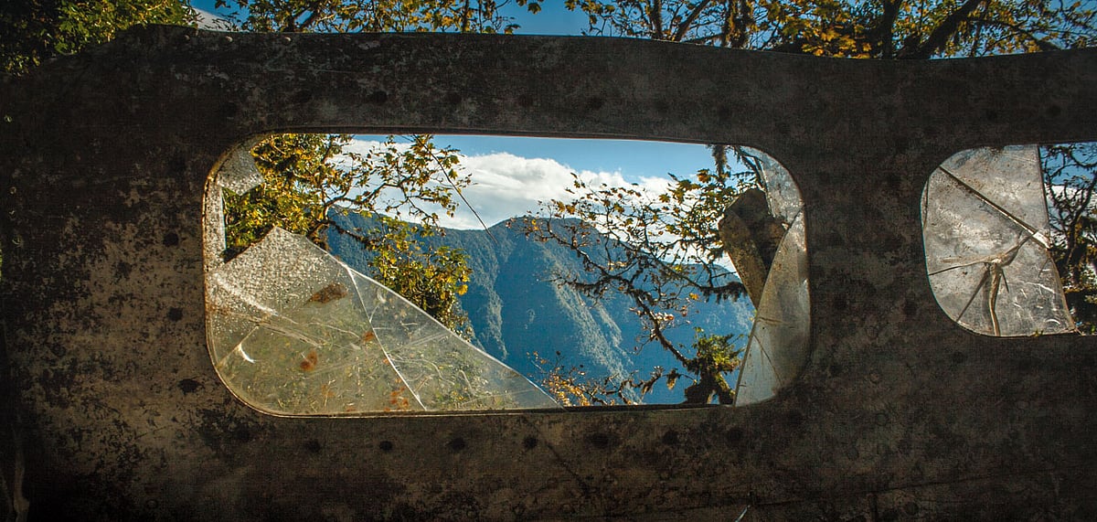Broken windows of the B-24 heavy bombers cockpit. The mountains beyond are in Myanmar