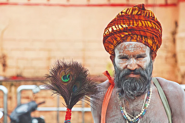 A devotee covered in ash outside the temple of Mahakaleshwar - Shutterstock