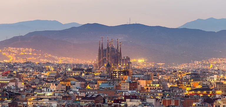 Barcelona city skyline and La Sagrada Familia at dusk - Shutterstock