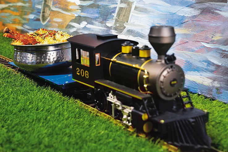 Set on a quirky train theme, each table here is a railway junction, toy train carrying food departs its onto the platform