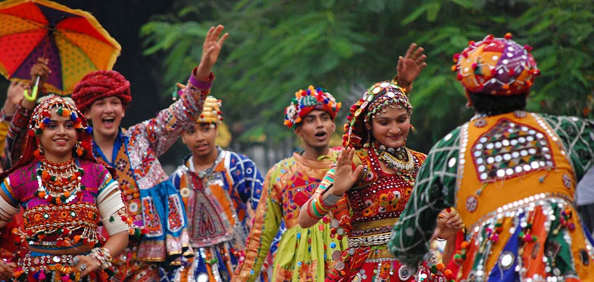 A group of people partake in the dance performance at the Rann Utsav