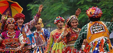 A group of people partake in the dance performance at the Rann Utsav