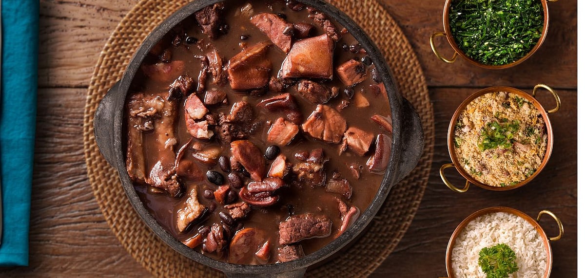 Feijoada is a hearty stew made of black beans, sausages and cuts of pork. Credit Shutterstock