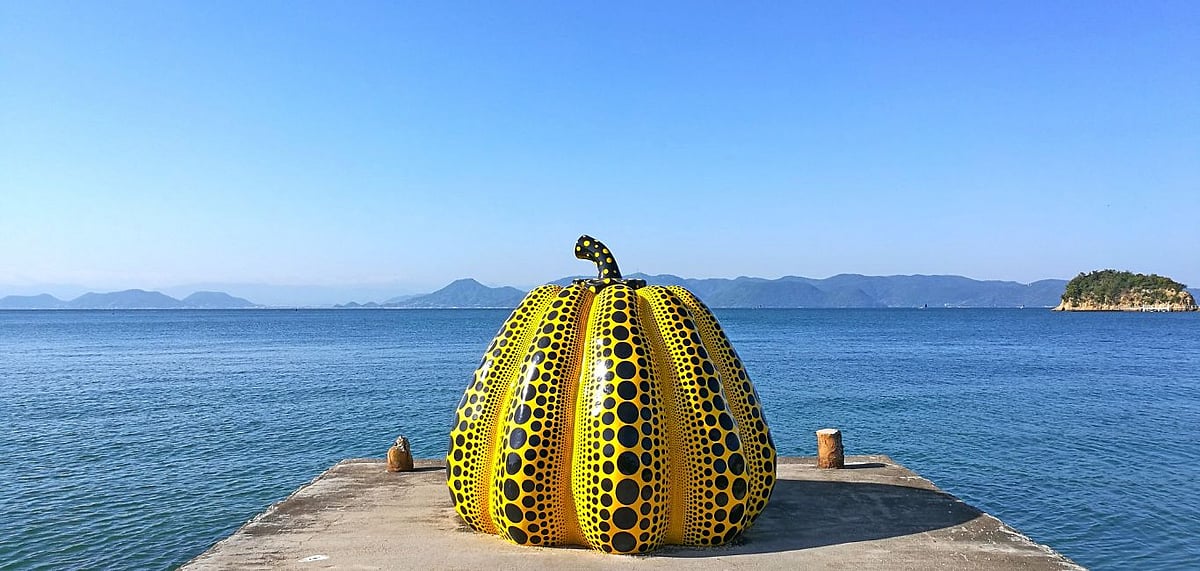 Shutterstock : A Yayoi Kusama pumpkin greets you as your ferry docks into the harbour of Japans Naoshima Art Island