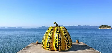 Shutterstock : A Yayoi Kusama pumpkin greets you as your ferry docks into the harbour of Japans Naoshima Art Island