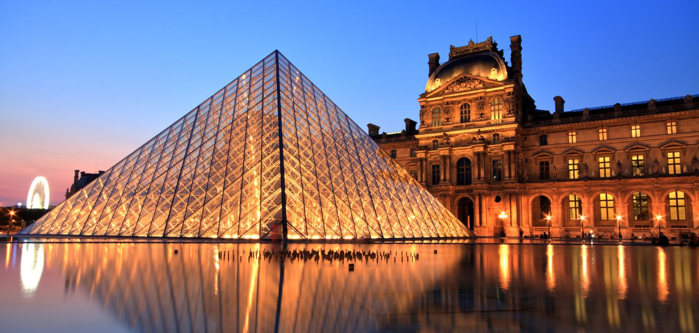 The Louvre Pyramid beckons with its contemporary allure - null