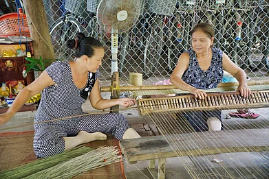 Women making tatami mats with grass in Vietnam Michael Habana Coronel / Shutterstock