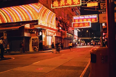 Temple Street in Hong Kong at night. Wong Kar Wais nightcrawler style cinematography in. Photo Credits Shutterstock