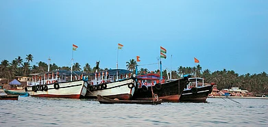 Fishing vessels anchored near the shore at Malvan