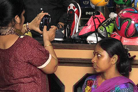 A Maidan Market shopper photographing shoes