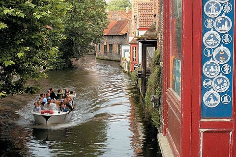 Tourists take a boat tour in Bruges