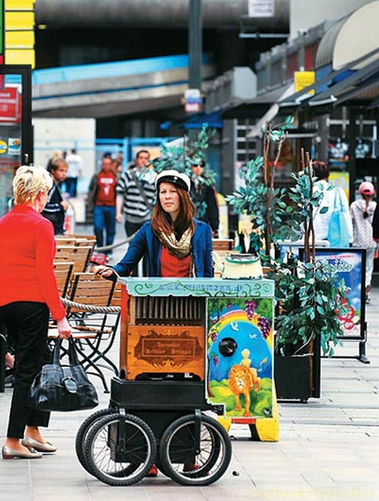A street artist plays a barrel organ