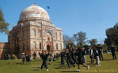 Children play outside the Bada Gumbad, at Lodi Gardens