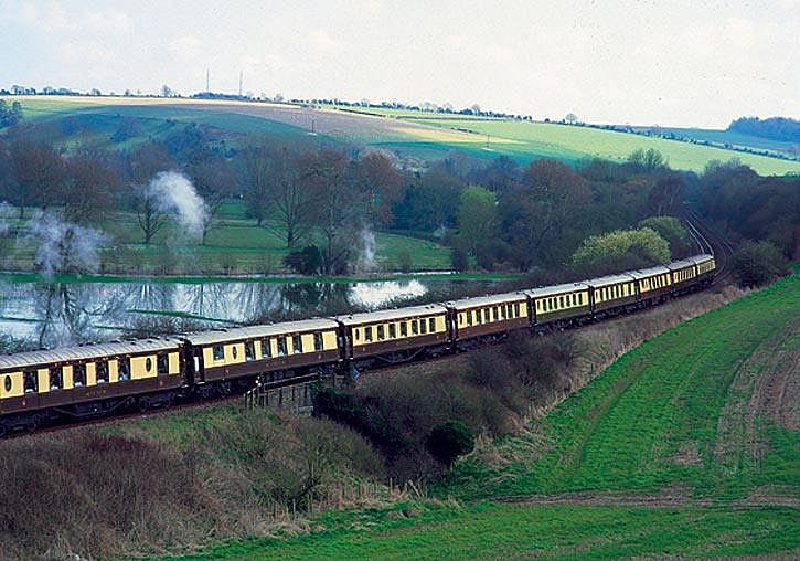 The British Pullman winds through the picturesque British countryside