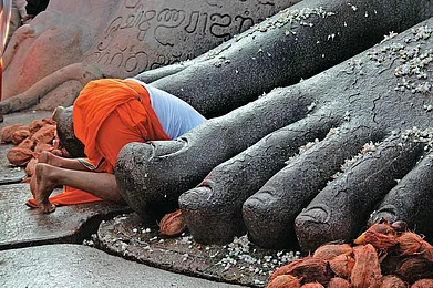 A devotee at the feet of the statue