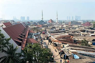 The view from the watch tower with the village of Luar Batang and its mosque in the foreground