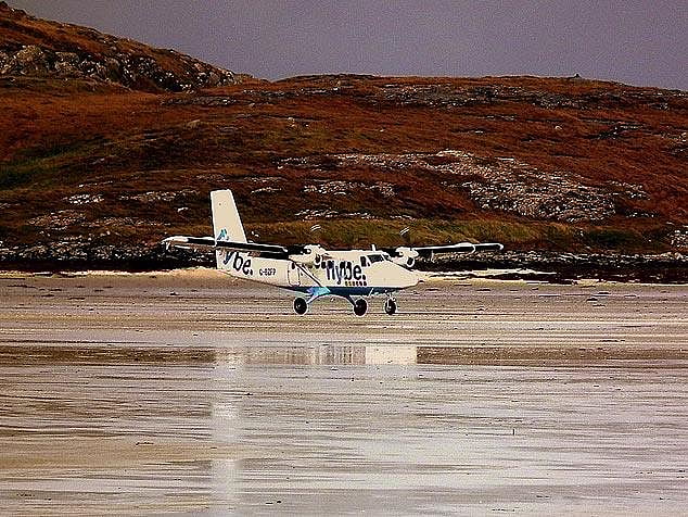 Landing on a beach at the Barra Airport, Scotland