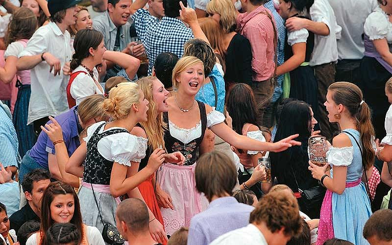 Dressed in traditional dirndls, young Muncheners soak in the spirit