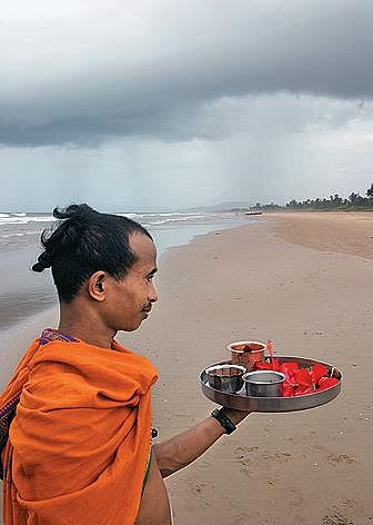 A priest on his way to the temple via the Om beach