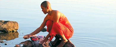 Depositphotos : A nun washes clothes in the Irrawaddy. More than 2,100 kilometres long, the river begins in the foothills of the Himalayas and tumbles into the Andaman Sea