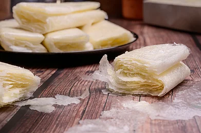 Shutterstock/P.V.R.M : Putharekulu. Its delicate, crispy wafer-like layers are filled with a mixture of sugar and ghee