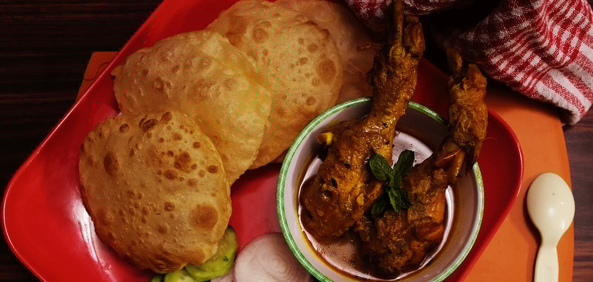 Delicious hot luchis with chicken curry