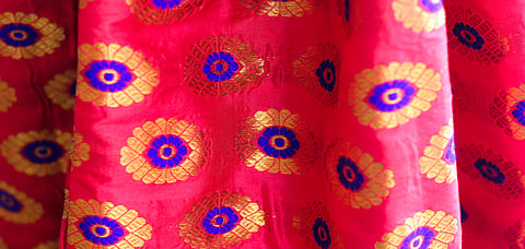 The paat silk mekhela chadars have intricate designs made out of golden silk threads or guna all over