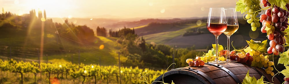 Glass Of Wine With Grapes And Barrel On A Sunny Background