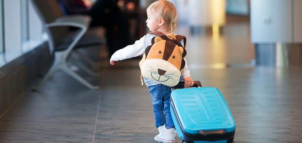 Flying with a young child can present its fair share of challenges. Photo Credit Shutterstock
