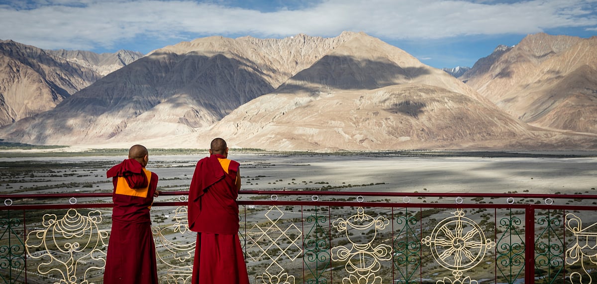 Monks survey the valley from Diskit monastery in Numbra