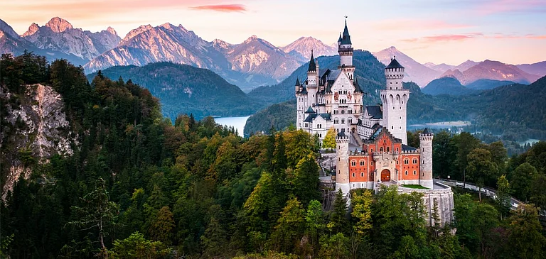 The Neuschwanstein Castle at the break of dawn - Shutterstock
