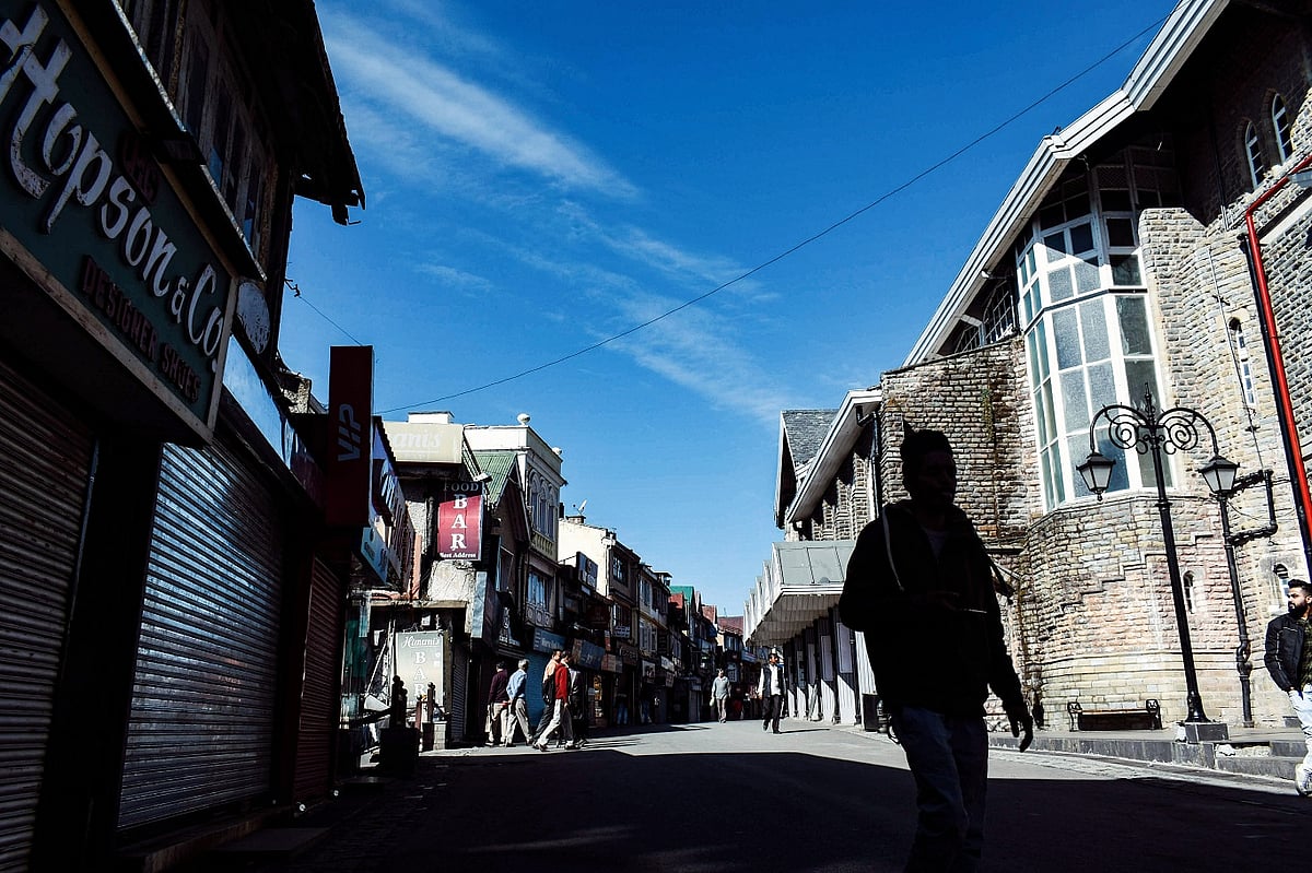 A man walks down the Mall Road in downtown Shimla 