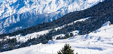 Shutterstock : Snow-clad mountains and forests enhance the beauty of hill stations