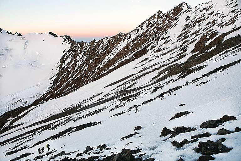 Trekkers heading up to a saddle on their way to climbing Stok Kangri
