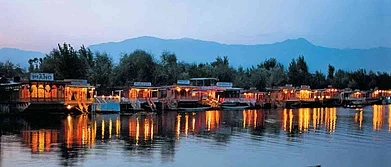 Lights from houseboats cast beautiful reflections on the Dal Lake