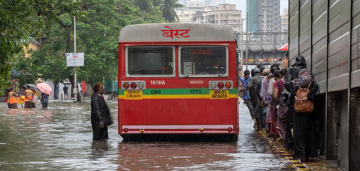 A passenger bus stuck in a water - logged road